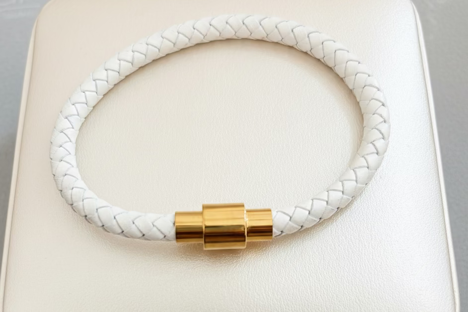 White braided leather bracelet, with gold magnetic stainless steel clasp. 8”x6mm